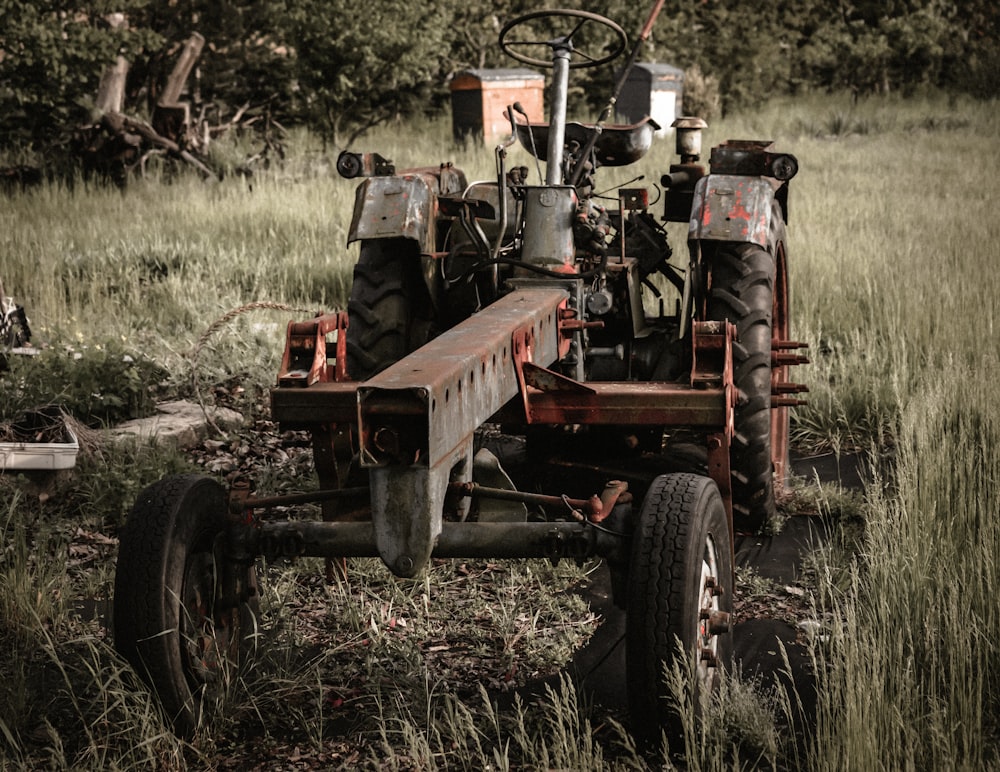 an old tractor is parked in a field