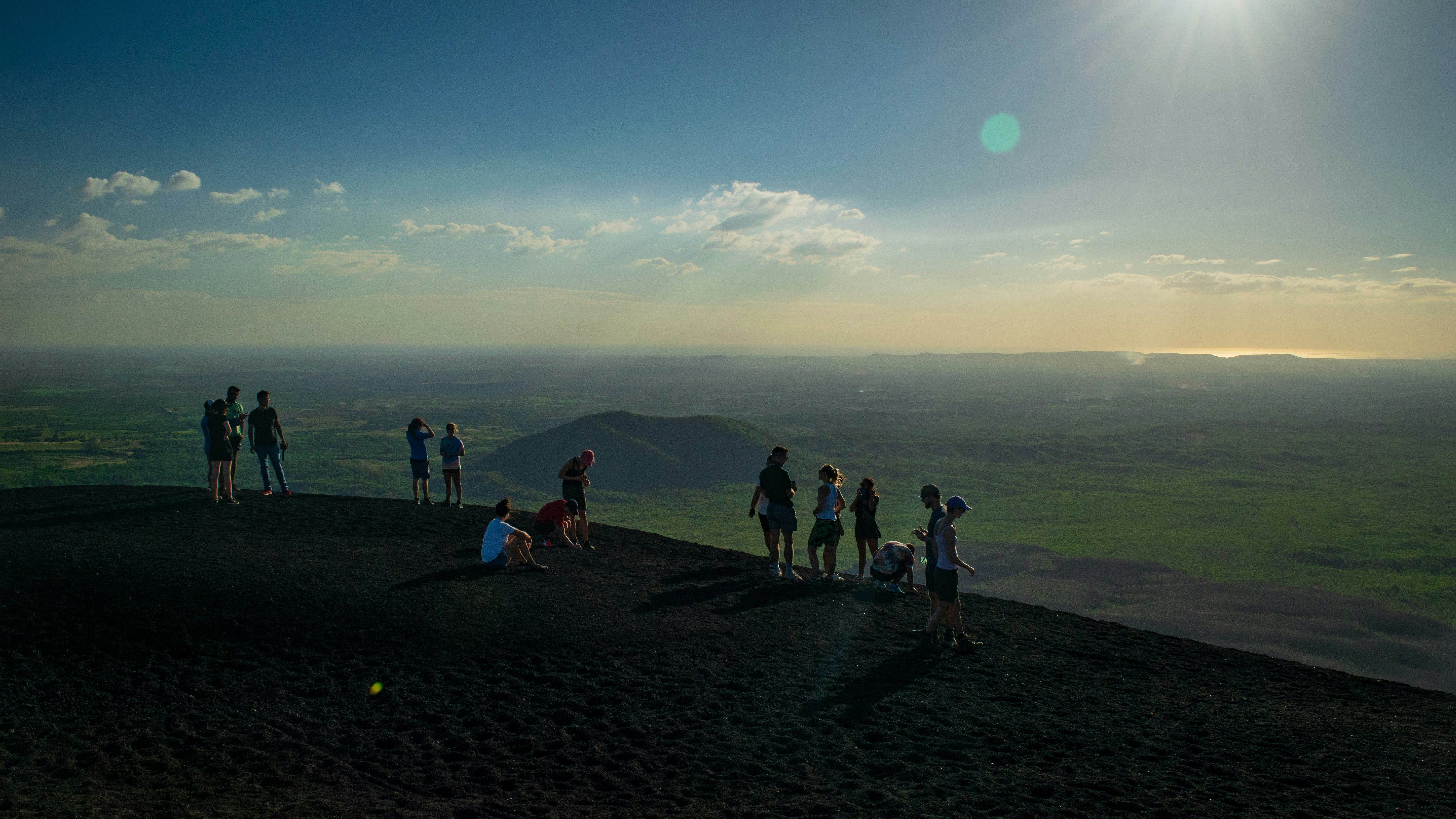 people standing on top of cliff during daytime, 