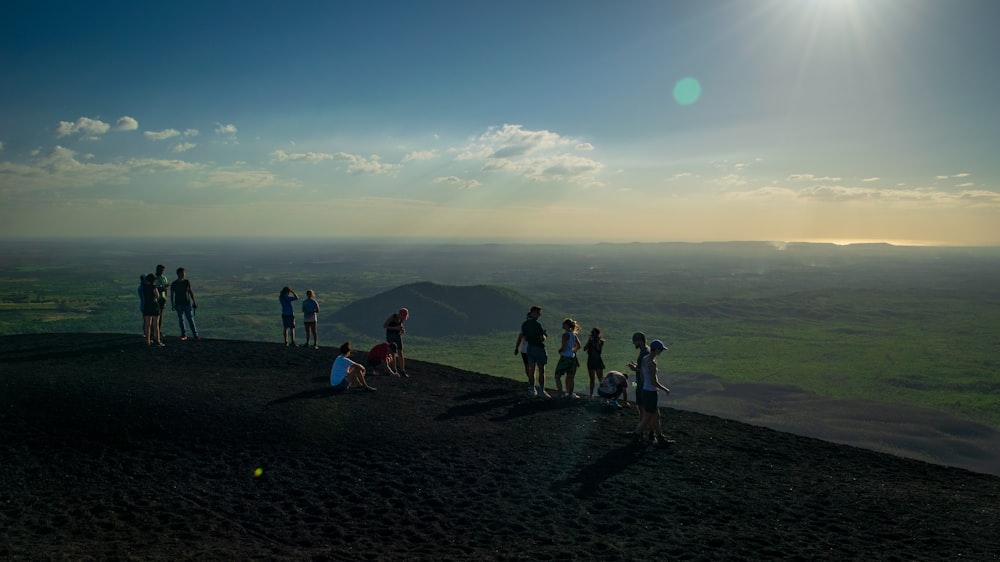 people standing on top of cliff during daytime