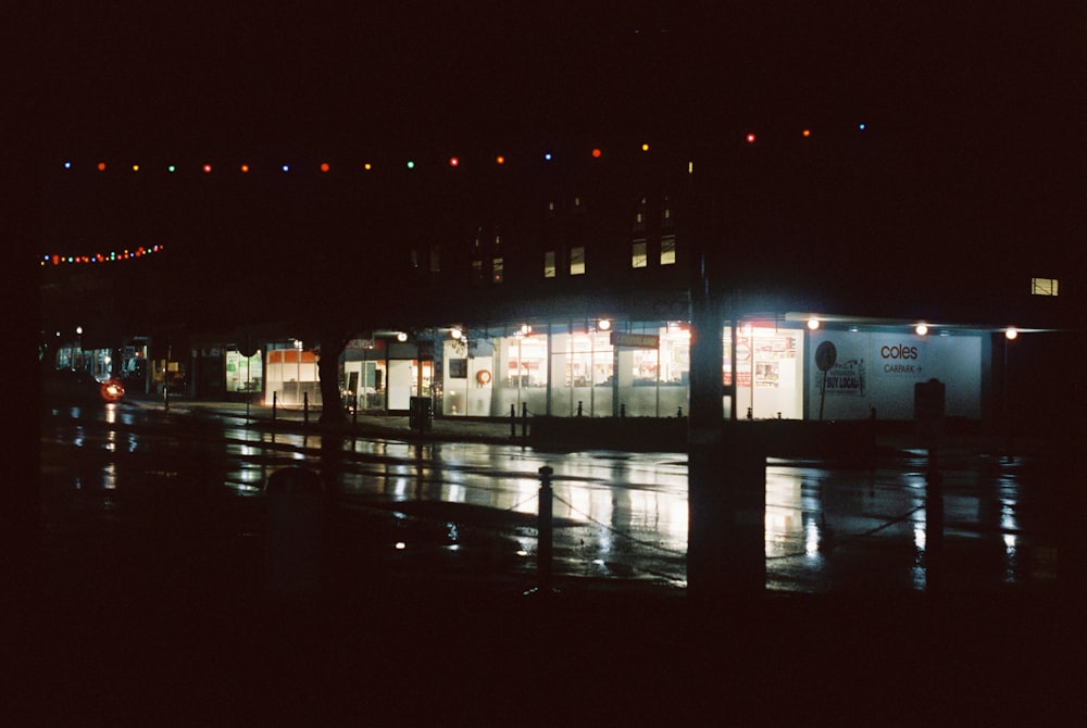 a row of buildings lit up at night