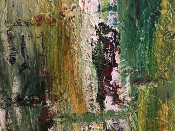 An abstract painting with thick brush strokes and a textured surface. The artwork features a blend of vibrant greens and yellows, with hints of red and black interspersed through the composition. The texture and colors create an impression of natural elements or foliage.