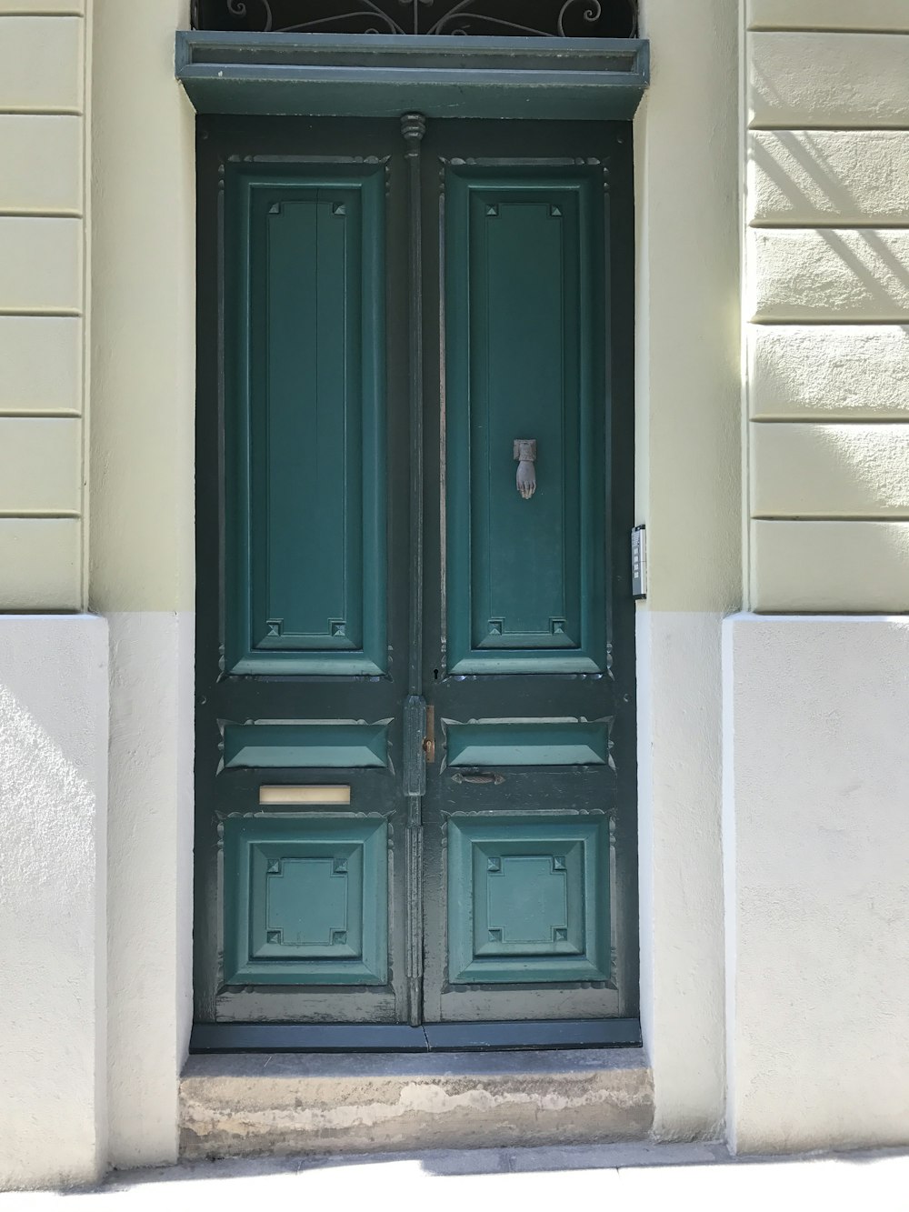 geschlossene Tür aus blaugrünem und schwarzem Holz