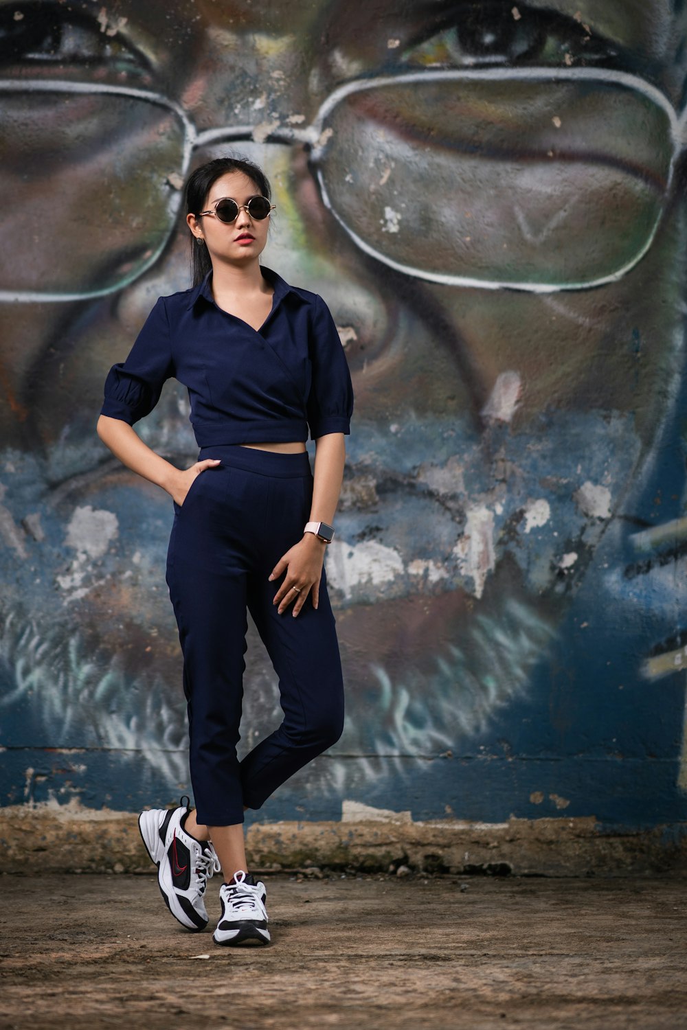 woman standing near wall mural