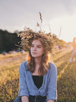 woman sitting down on grass