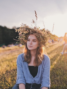 woman sitting down on grass