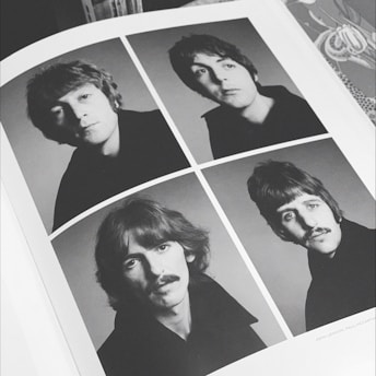 poster of four men on gray surface