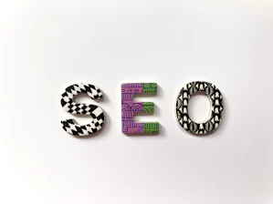 The letters S, E, and O with patterned surfaces on a white background