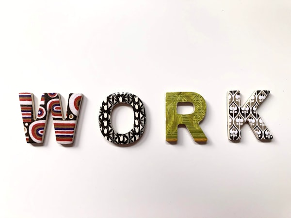 patterned 3-D letters spelling out the word "work"