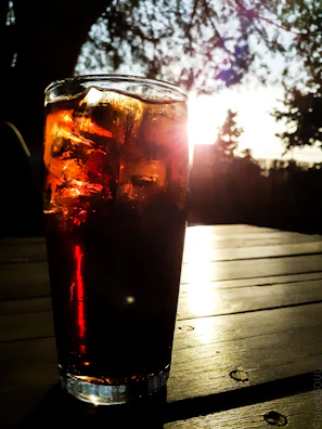 A cooler filled with refreshments sitting beside a shibumi shelter at sunset.