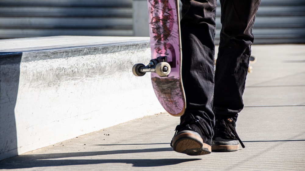 person holding purple skateboard