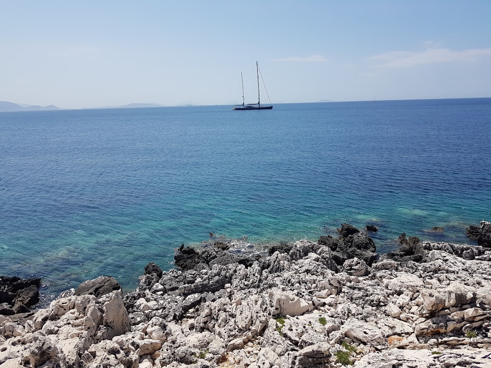 blue sailboat on ocean