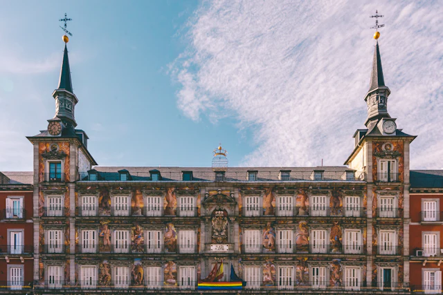The painted Casa de la Panadería in Plaza Mayor, blue sky