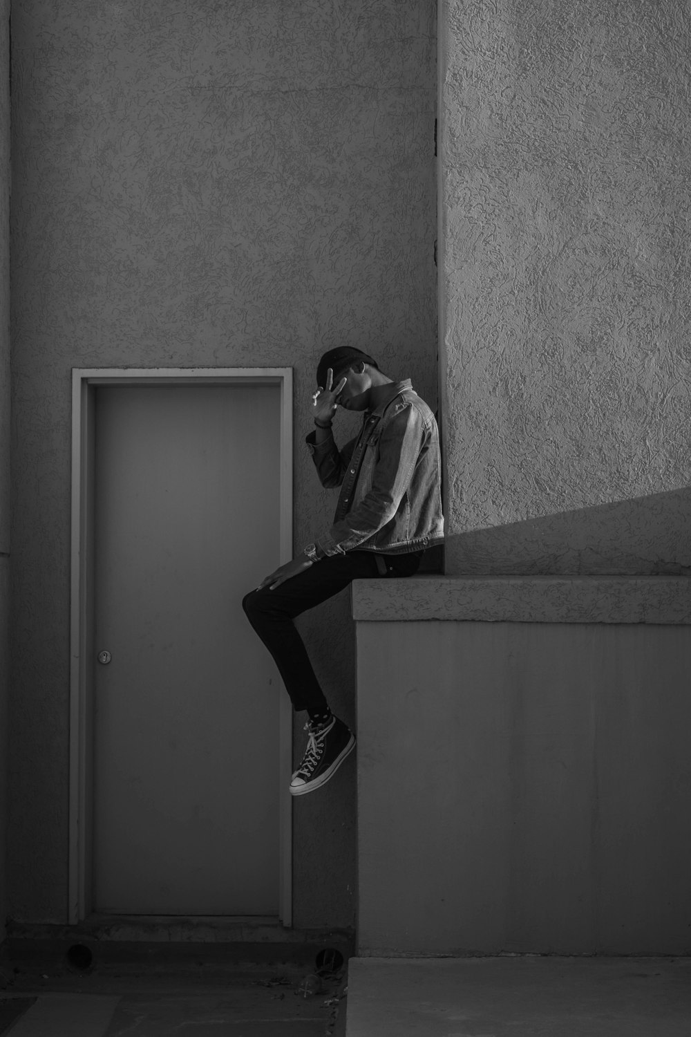 man sitting beside door