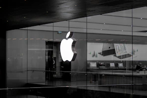 A welcoming store display featuring various Apple products with a deep purple and white color scheme.
