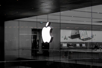 A sleek display of modern Apple products including iPhones, iPads, and MacBooks with soft natural lighting.
