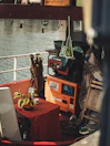 A small dining nook inside the houseboat with fresh flowers and local handicrafts.