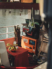 A small dining nook inside the houseboat with fresh flowers and local handicrafts.