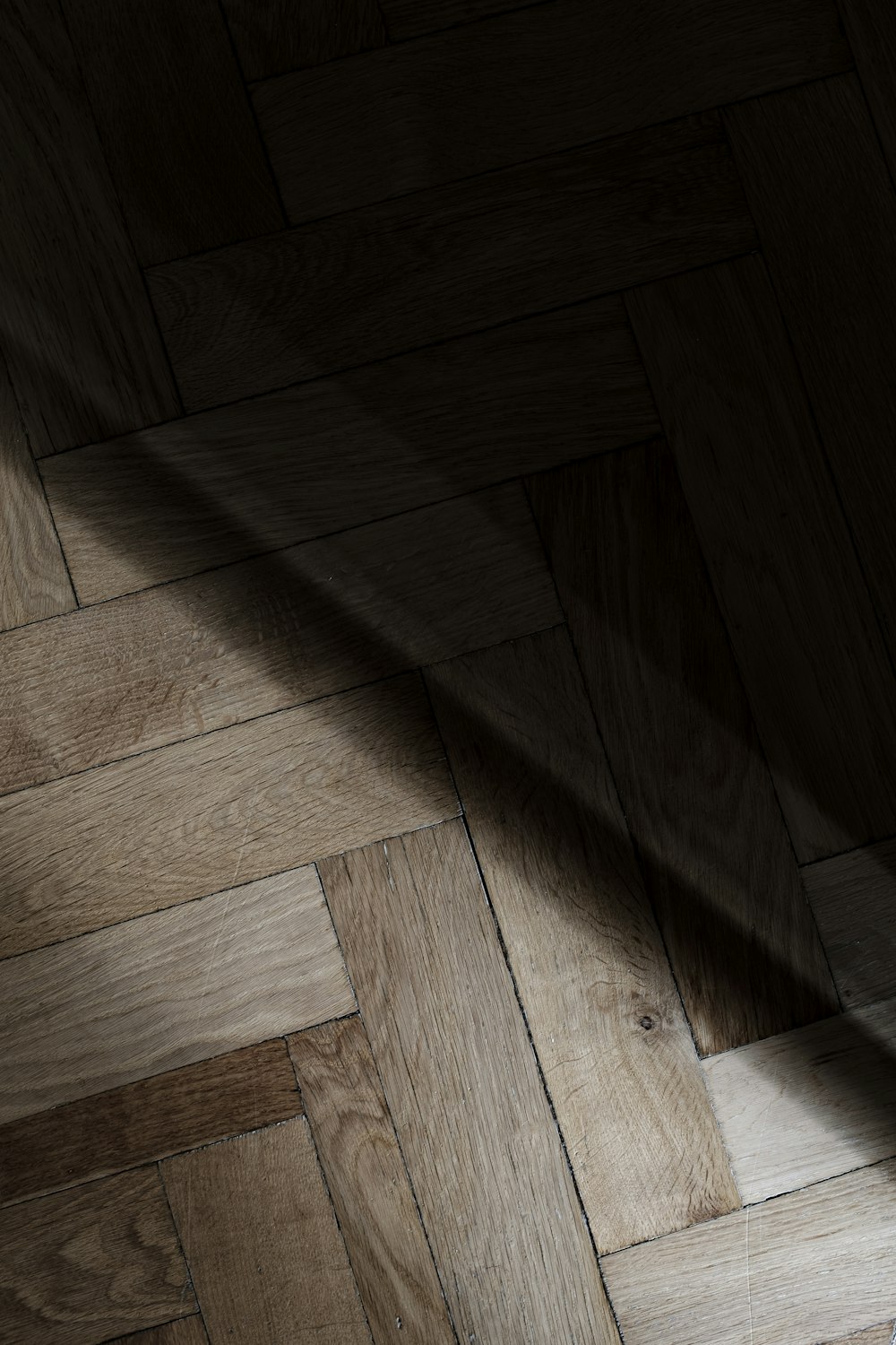 a wooden floor with a light shining on it