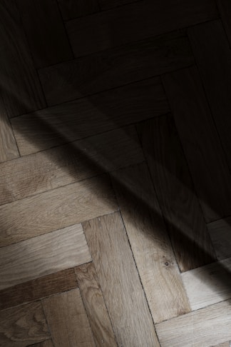 a wooden floor with a light shining on it