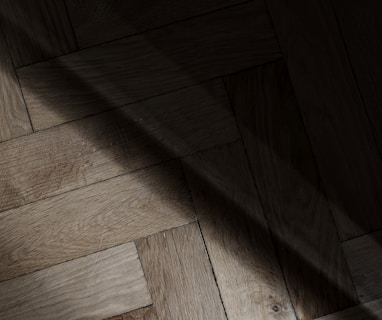 a wooden floor with a light shining on it