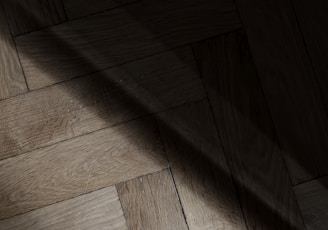 a wooden floor with a light shining on it