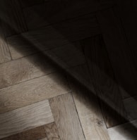 a wooden floor with a light shining on it