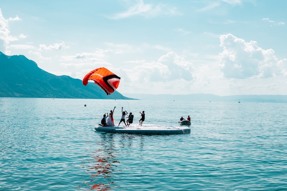 people on boat on body of water