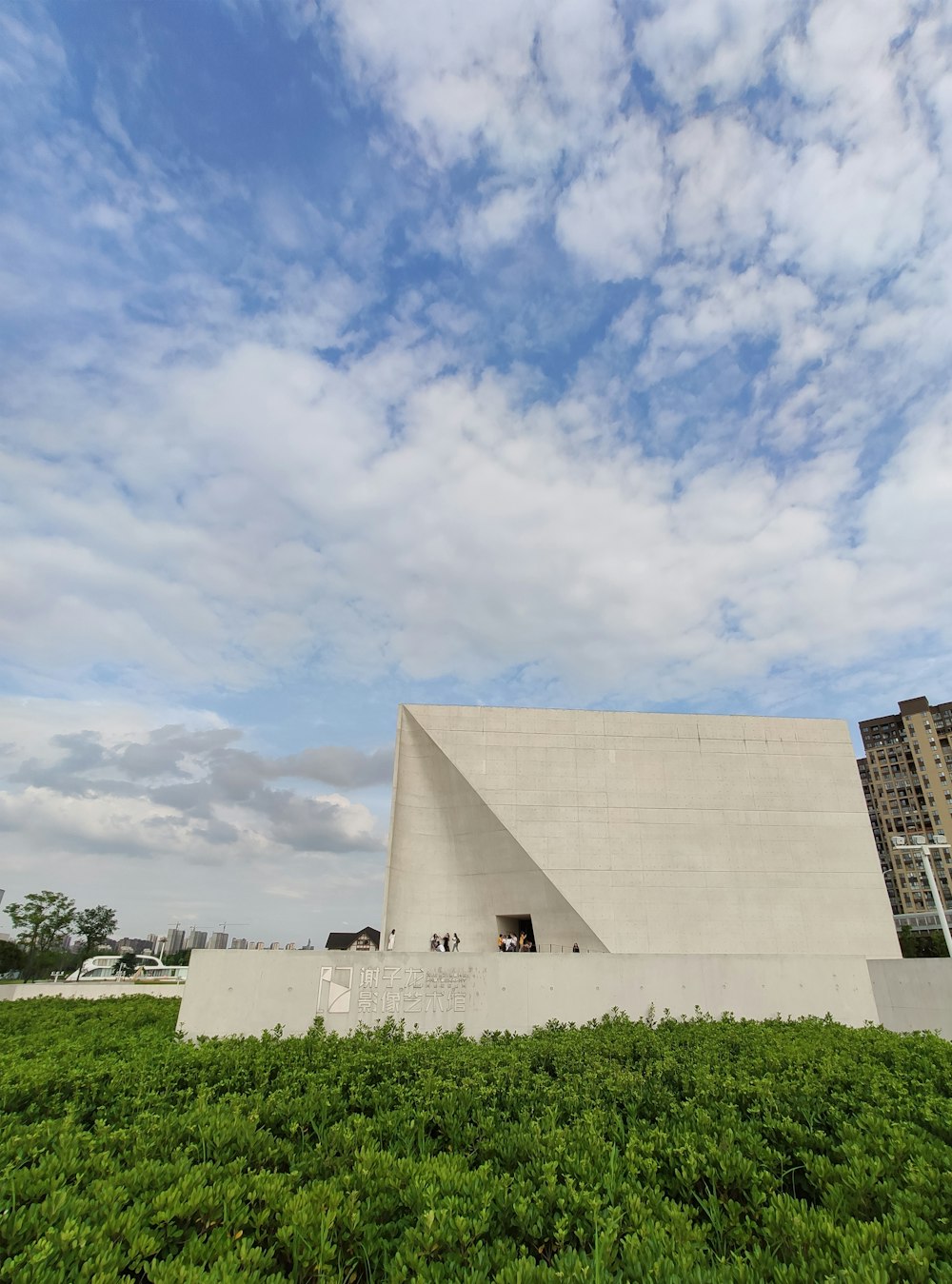 white concrete house under white and blue sky at daytime