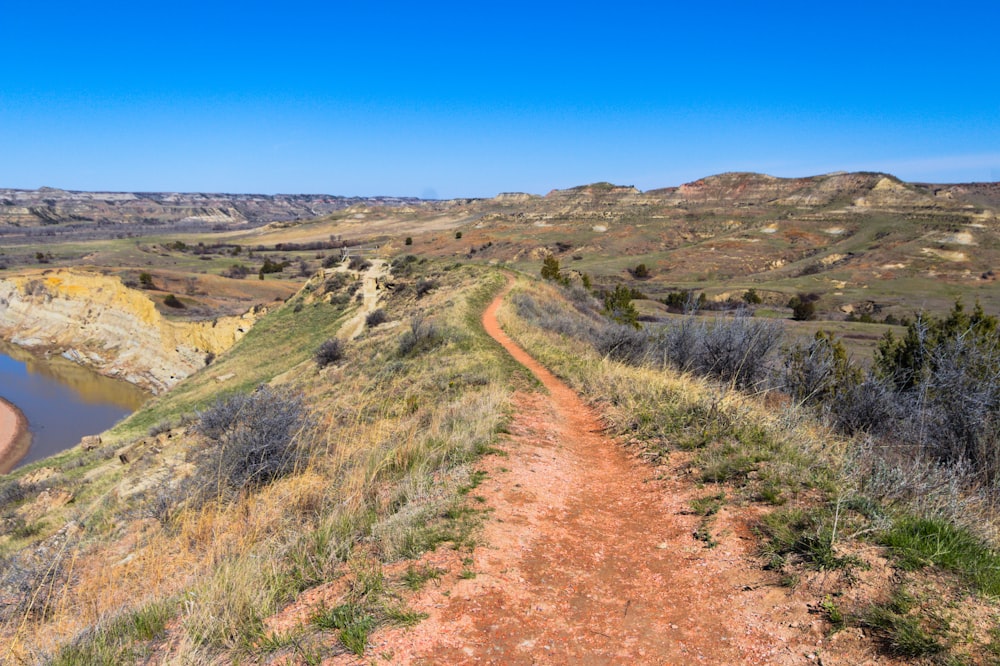 green grass mountain under blue sky during daytime