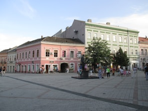 A picturesque town square with colorful buildings and people.