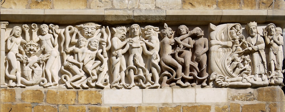 a group of statues on the side of a building