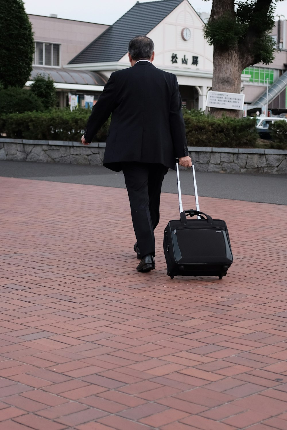 man pulling softside luggage