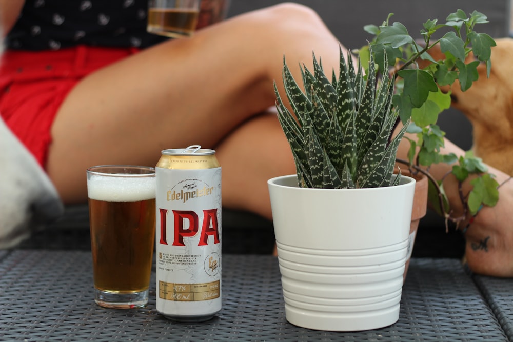 Ipa drinking tin can beside drinking glass