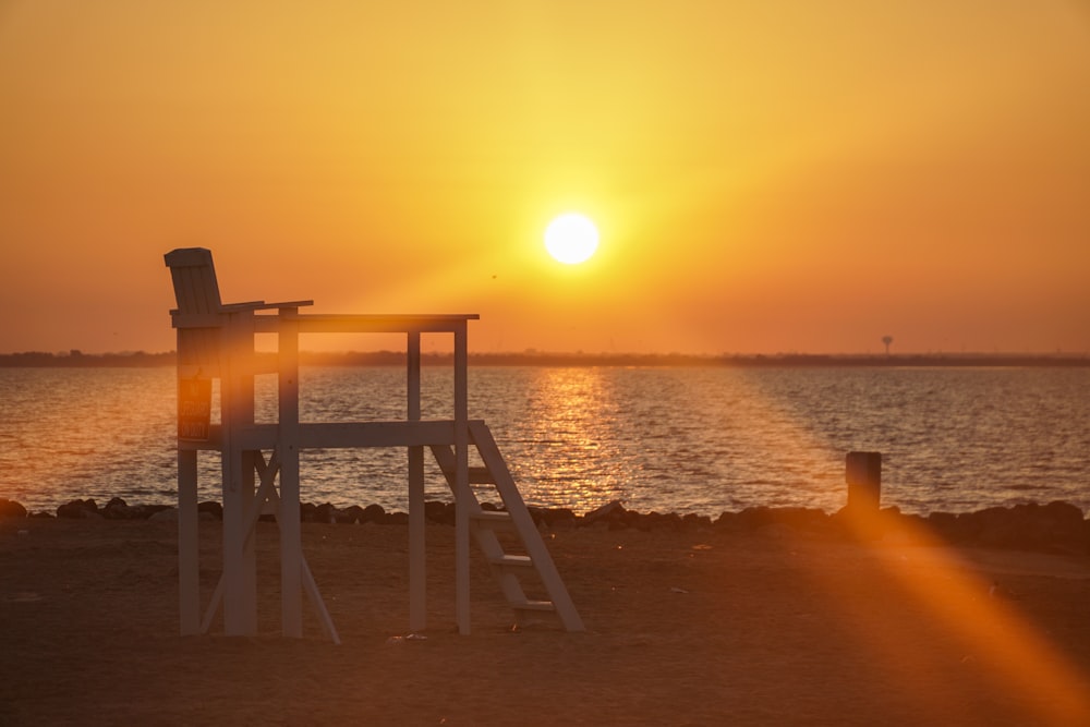 white wooden building near a body of water during golden hour