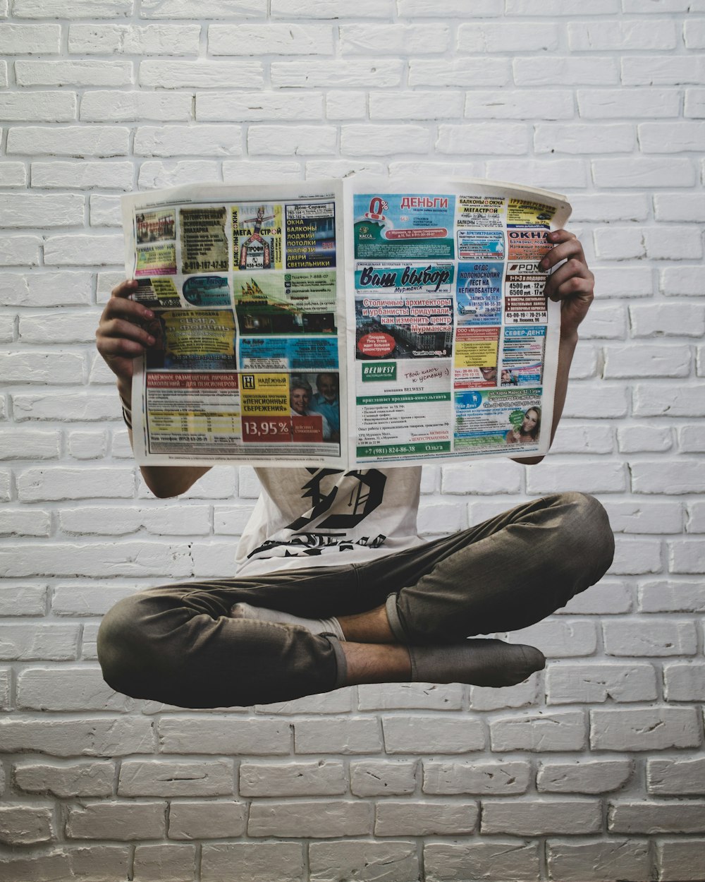 person holding newspaper article