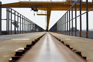 A panoramic view of a railway infrastructure project with cranes and steel frameworks.
