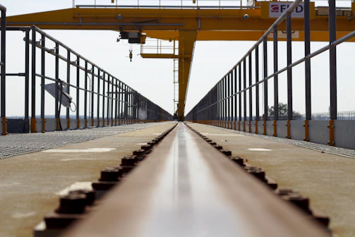 A panoramic view of a railway infrastructure project with cranes and steel frameworks.