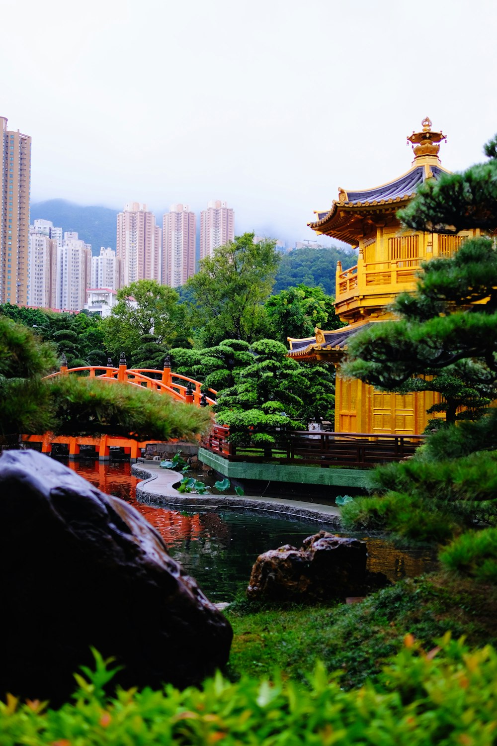 temple near bridge and trees during day