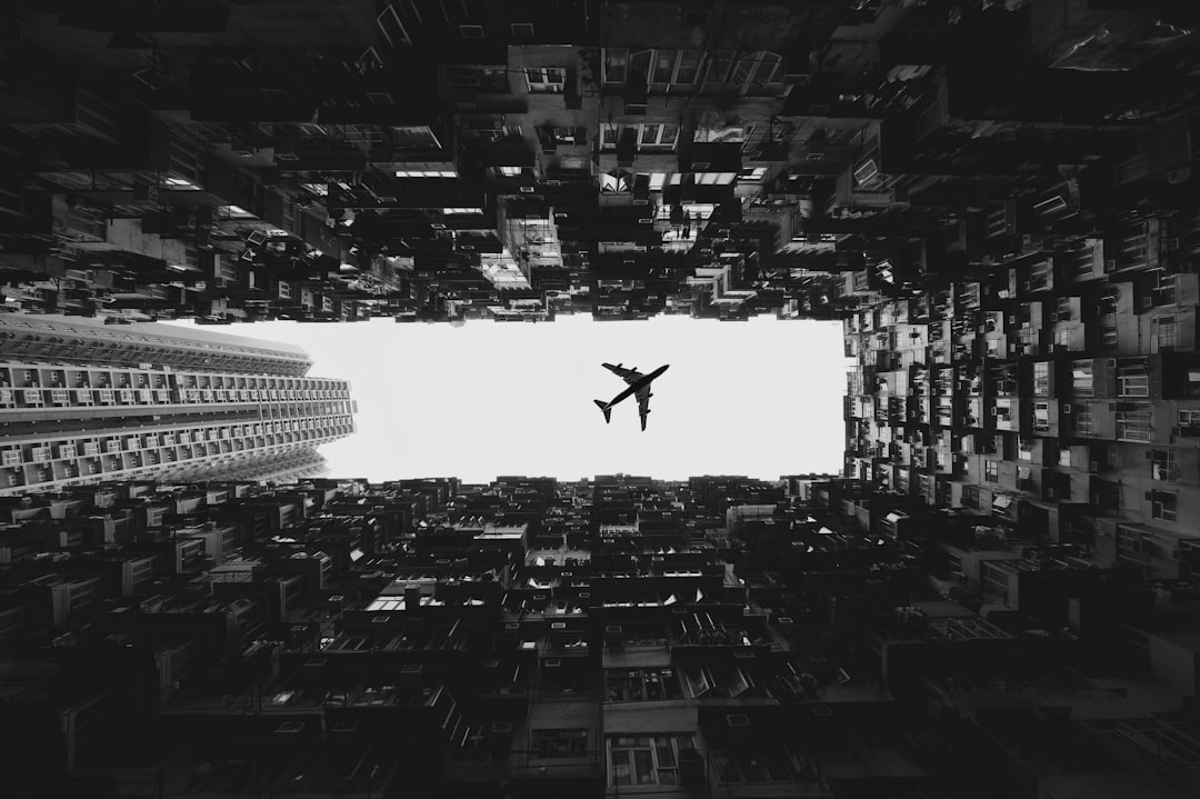 airliner on flight, © pixelperfektion – thank you, for crediting and supporting us!</p>
<p></p>
<p>Hongkong skyscrapers, framing a plane passing by