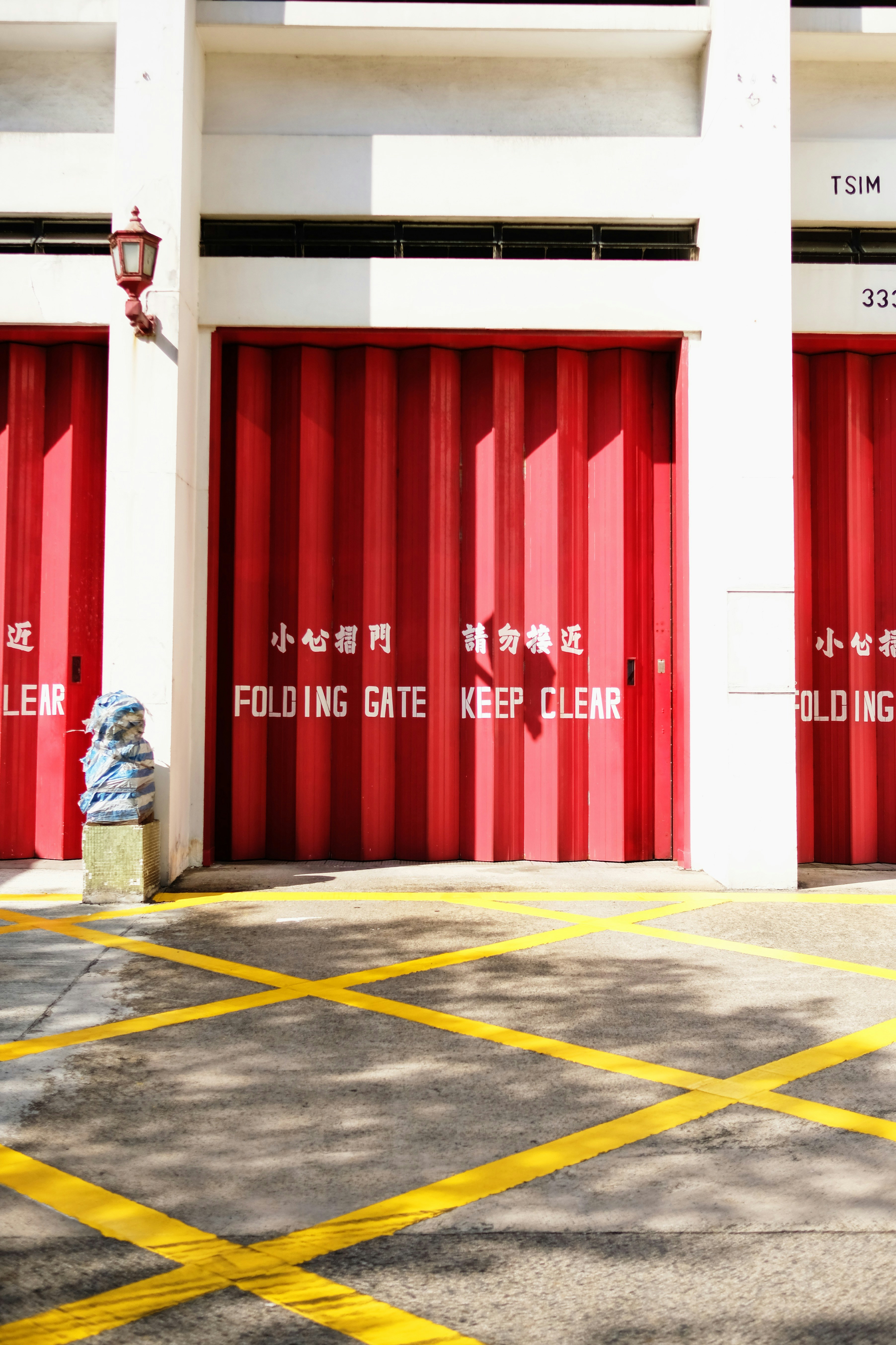 © pixelperfektion – thank you, for crediting and supporting us! <br /><br />Firedepartment in Hongkong with vibrant red doors and geometric, yellow lines on the ground