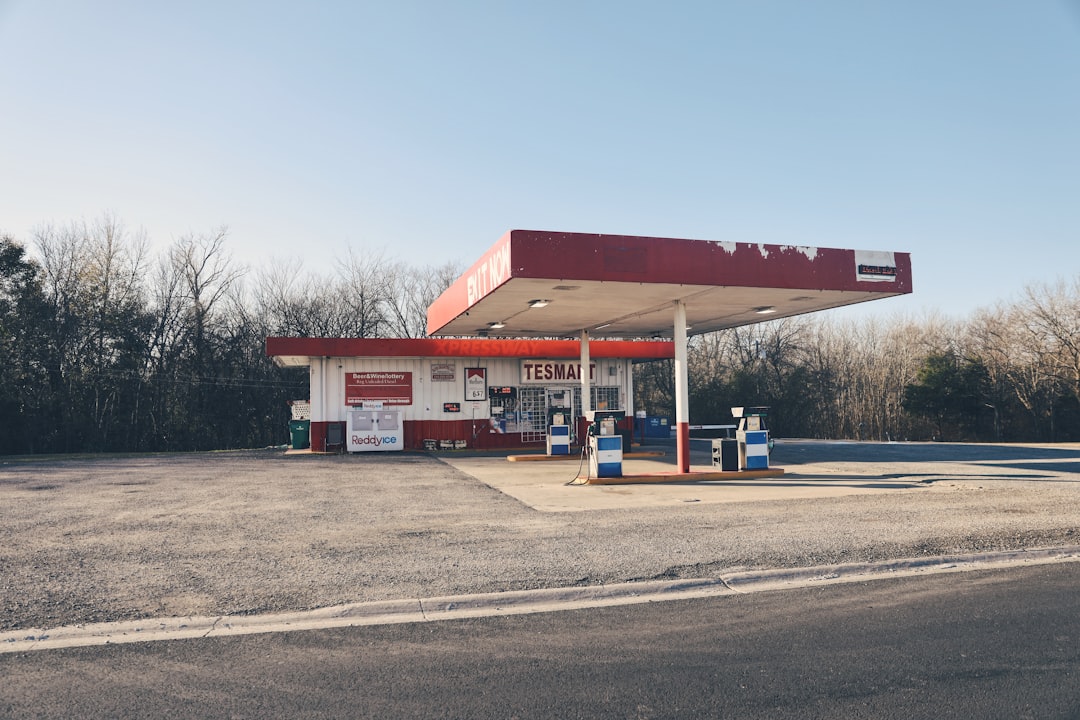 white and red gasoline station under calm blue sky during daytime