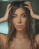 naked woman holding head with both hands