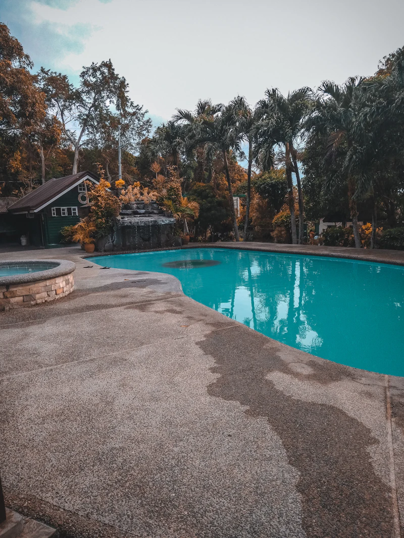 Poolside loungers under palm trees at a Daman beach resort