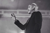 A close-up of a passionate speaker sharing ideas with animated gestures.