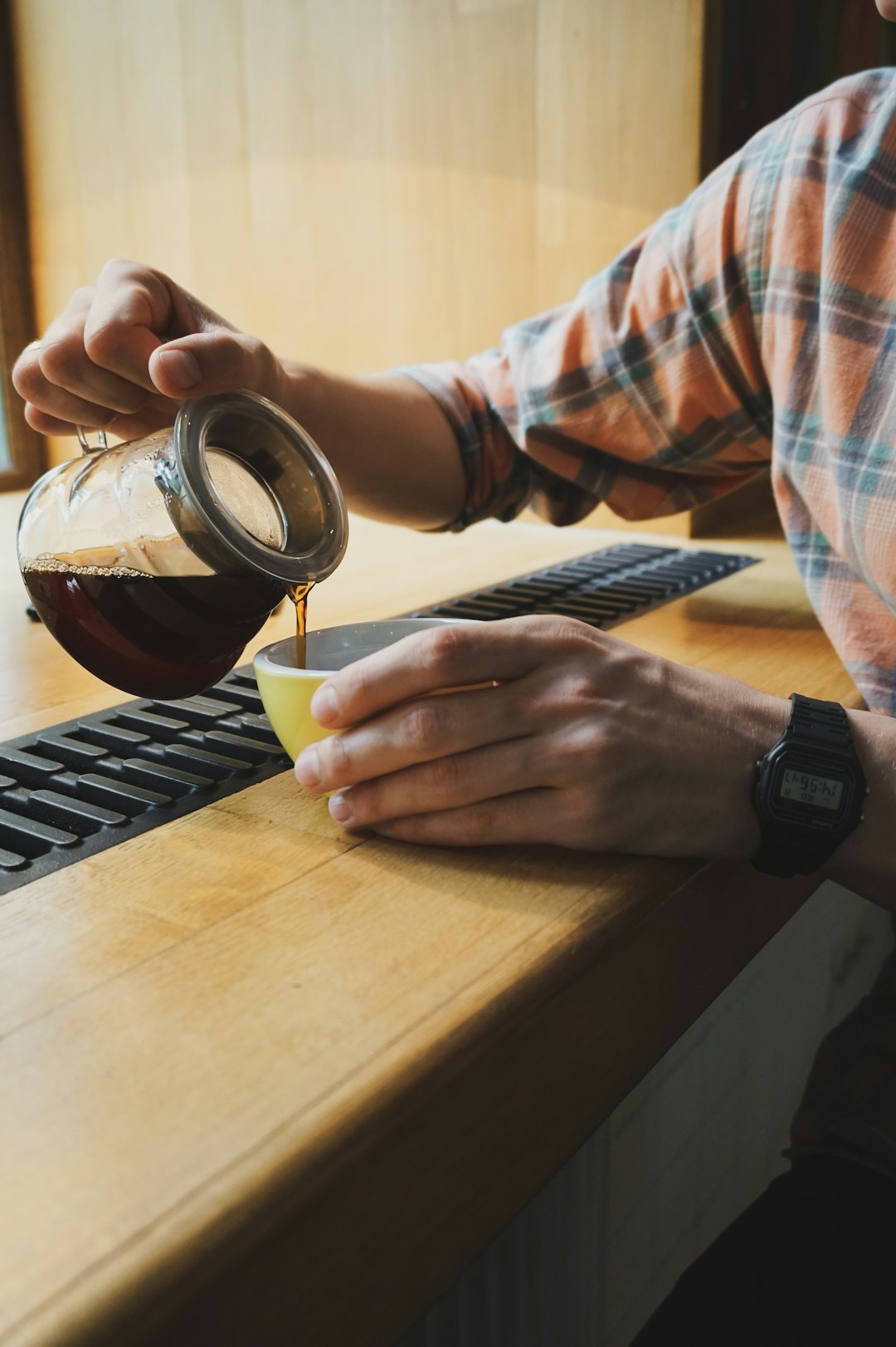 person pouring coffee on cup