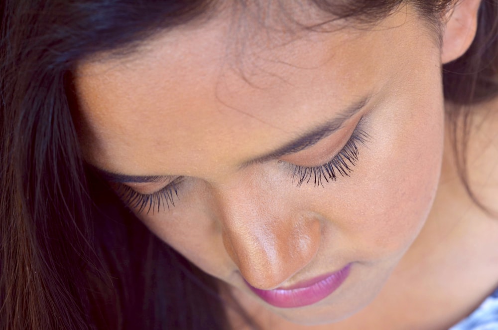 shallow focus photo of woman in white and blue top