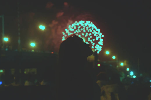 silhouette of woman standing near tree