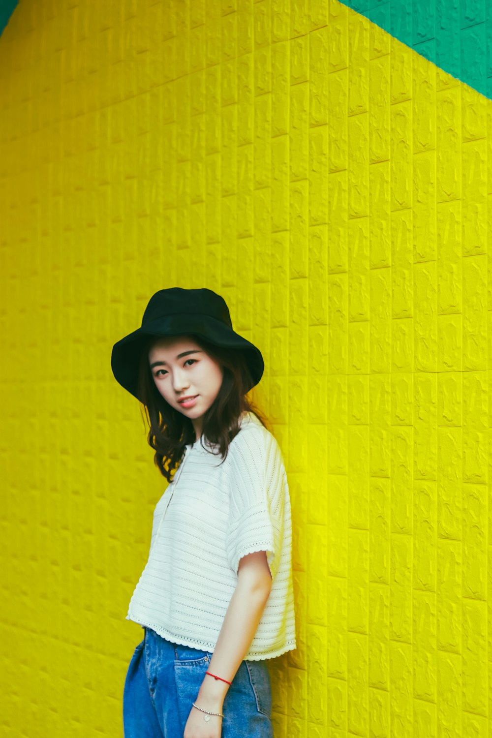 woman standing and leaning on yellow all