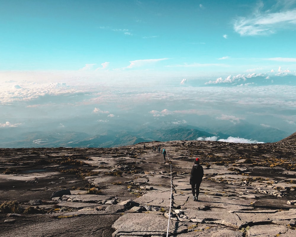 a man standing on top of a rocky mountain