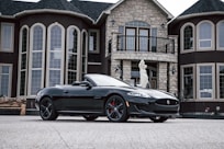 black convertible vehicle parked outside house